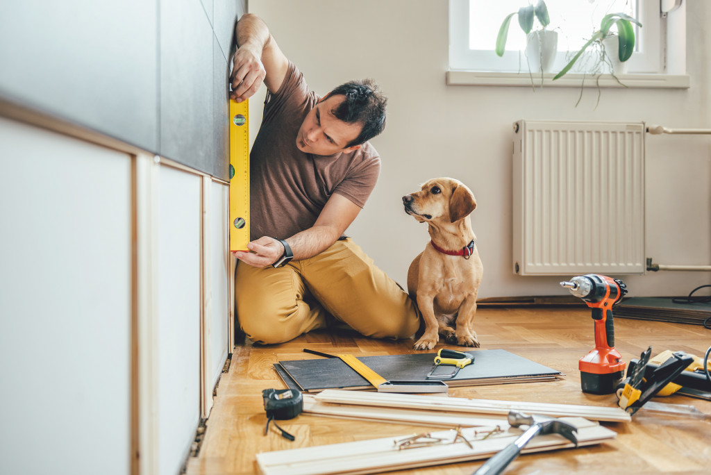 man doing carpentry with a dog