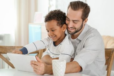 father and son using a gadget