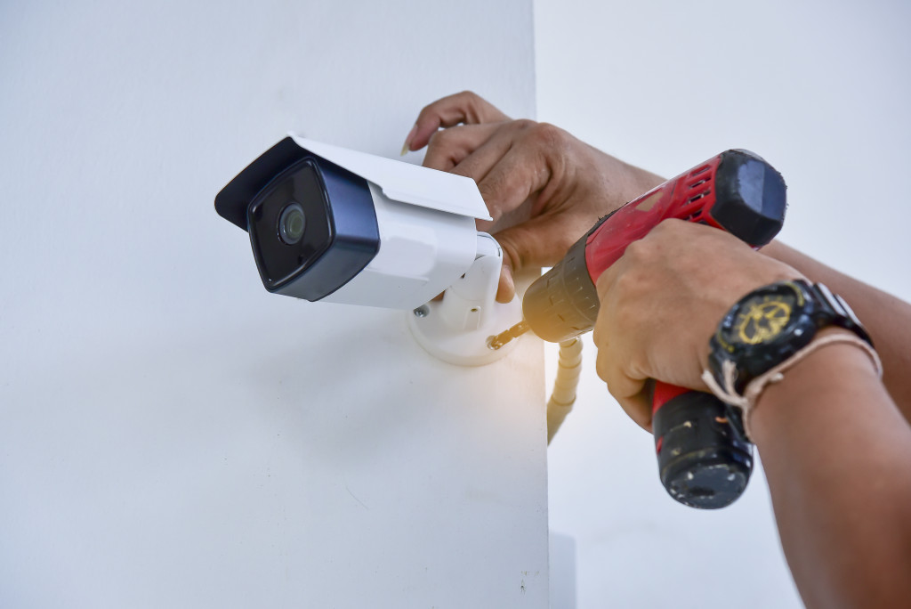 man installing a security camera