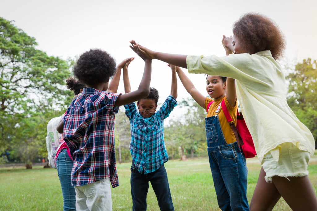 group of african american children joining their hands concept of diversity